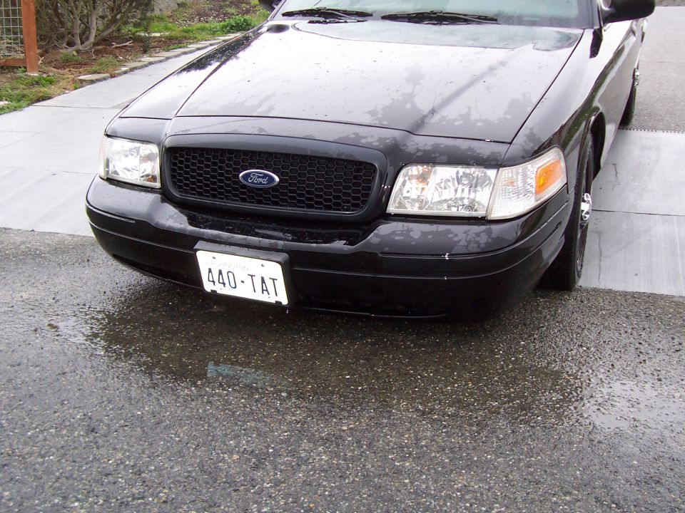 Black 2003 Ford Crown Victoria front view with license plate 440-TAT