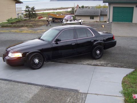 2003 Ford Crown Victoria - 2003 Ford Crown Victoria parked in front of a house with a water view.