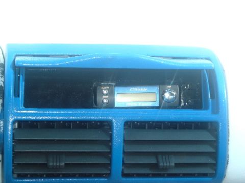 1989 Ford Probe - Aftermarket stereo installed in a car's dashboard, surrounded by blue paint and air vents.