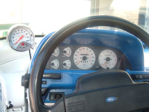 1989 Ford Probe - The dashboard features a tachometer and speedometer, along with other gauges and a Ford steering wheel.