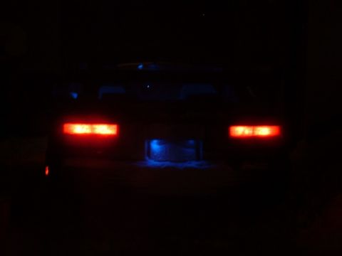1989 Ford Probe - Rear view of a car at night, showing illuminated taillights and underglow lighting.