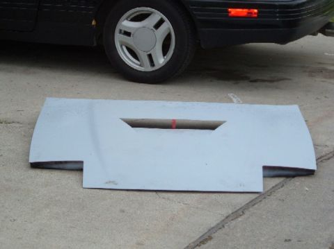 1989 Ford Probe - A car's rear bumper or valence panel is shown on the ground, with a portion of the vehicle visible above.