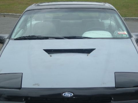 1989 Ford Probe - Front view of a 1989 Ford Probe, a distinctive hood scoop and pop-up headlights.