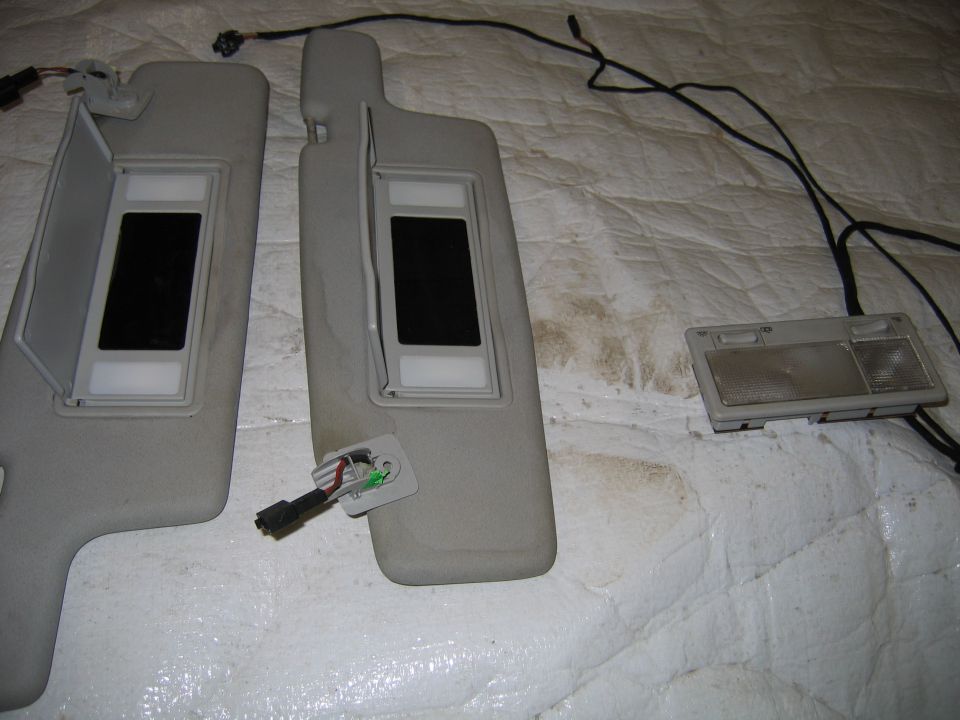 Two car sun visors with vanity lights and a dome light assembly with wiring