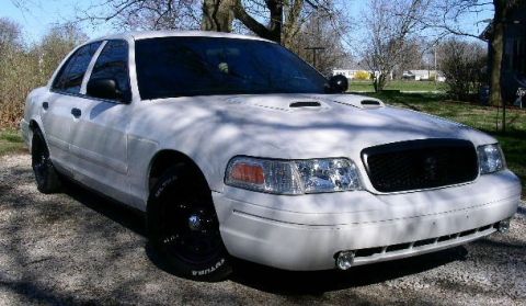 2001 Ford Crown Victoria - White 2001 Ford Crown Victoria with aftermarket hood scoops and black wheels.