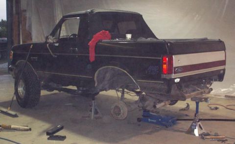 1988 Ford Bronco - Springs off and rear end resting on the jack.