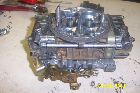 1979 Ford F-150 - A close-up view of a carburetor, showing its intricate mechanical components and metallic finish.
