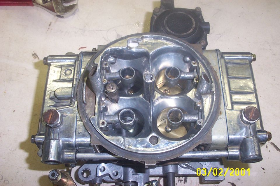 Quadrajet carburetor with visible throttle plates and fuel bowls