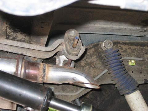 1995 Ford Bronco - Underside view of a vehicle's exhaust system and suspension, including a blue shock absorber.