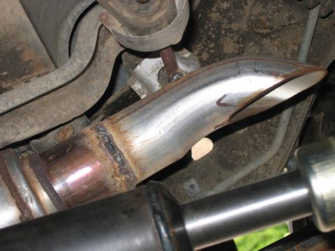 1995 Ford Bronco - Underbody view of vehicle exhaust system components, showing welds and suspension parts.