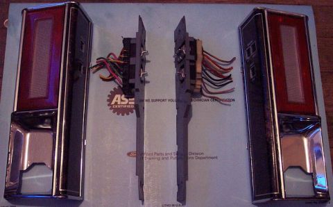 1985 Ford LTD Crown Victoria - Two tail light assemblies and wiring harnesses are laid out on a document with text and logos.