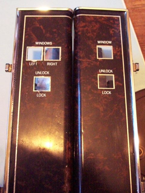1985 Ford LTD Crown Victoria - Close-up of woodgrain power window and lock controls, likely from a car interior.