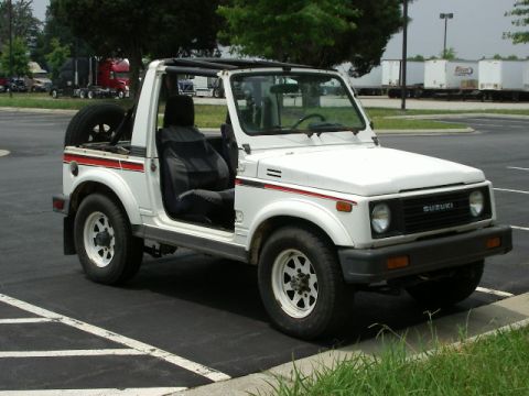 1988 Suzuki Samurai - This 1988 Suzuki Samurai is seen from a three-quarter front angle, parked outdoors.