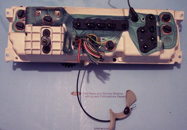Back of a dashboard instrument cluster with wiring harness and connectors