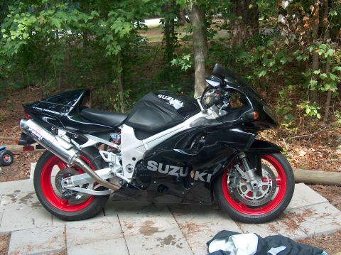2002 Suzuki TL1000R - A black 2002 Suzuki TL1000R motorcycle with red wheels is parked outdoors on a paved surface.