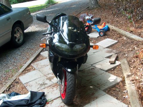 2002 Suzuki TL1000R - Front view of a black 2002 Suzuki TL1000R motorcycle parked on pavers.