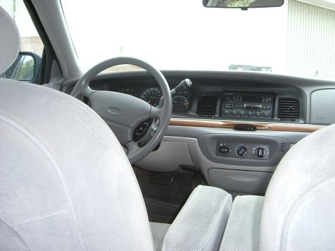 1996 Ford Crown Victoria - The dashboard and interior of a car are visible from the passenger seats.