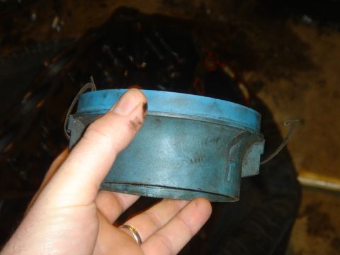 1986 Ford Mustang - A blue automotive part, possibly from a Ford Mustang, is held in a hand for inspection.