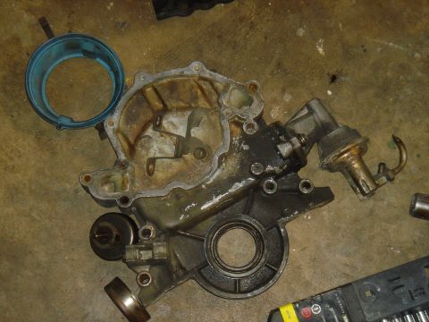 1986 Ford Mustang - Engine timing cover and fuel pump assembly, likely removed for repair or replacement.