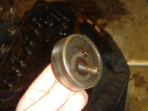1986 Ford Mustang - A close-up of a metal component, possibly a bearing or pulley, held in a person's hand.