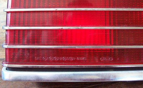 1985 Ford LTD Crown Victoria - A close-up of a red taillight assembly, showing embossed text and the Ford logo, suggesting a 1983 model year.