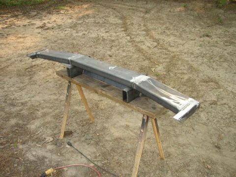 1995 Ford Bronco - A custom-fabricated steel bumper is shown resting on sawhorses outdoors.