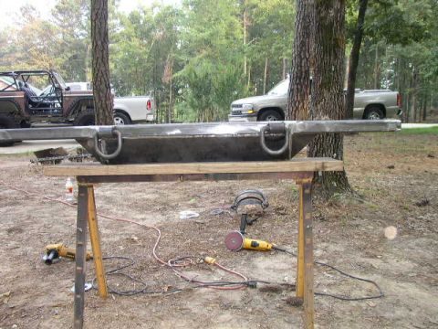 1995 Ford Bronco - A custom metal bumper with D-rings is shown on sawhorses, with a Bronco and a pickup truck in the background.