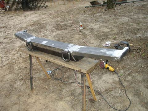 1995 Ford Bronco - Custom metal bumper with D-rings, likely for an off-road vehicle, being worked on outdoors.