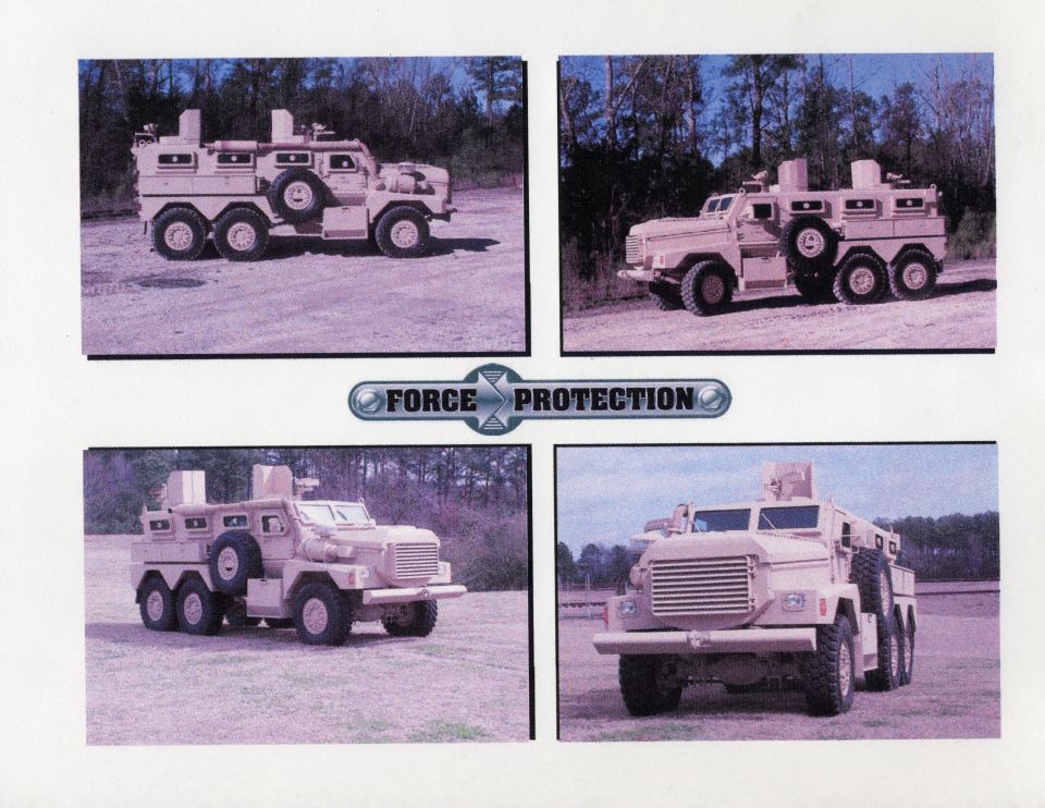 Tan armored vehicle with six wheels, spare tire mounted on the side, and a turret on top. Text reads FORCE PROTECTION
