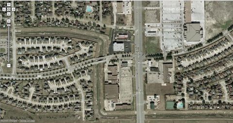 2000 Ford Crown Victoria - This aerial photograph shows a suburban neighborhood adjacent to a commercial development and a highway.
