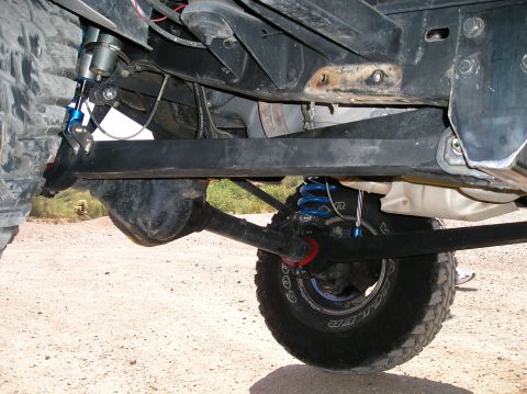1993 Ford Bronco - Close-up of a modified truck's undercarriage, highlighting the suspension system and differential.