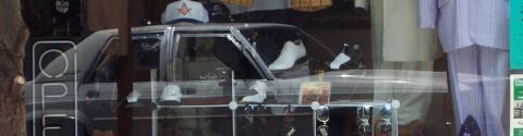 1985 Ford Crown Victoria LTD - A store window display features a car interior with shoes and other items.