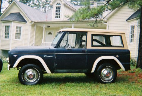 1967 Ford Bronco - This 1967 Ford Bronco is seen from the side, a dark blue body and a tan hardtop.