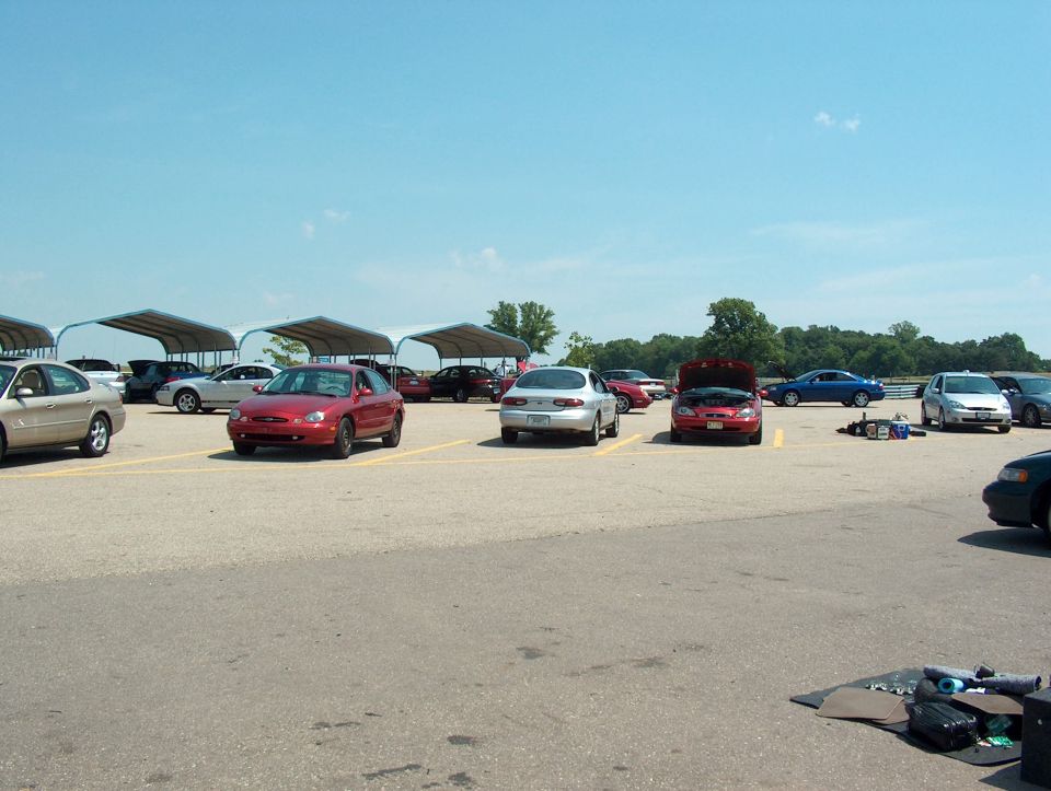 Parking lot with many cars under canopies and in open spaces