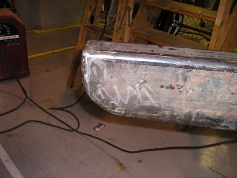 1996 Ford Bronco - A chrome bumper section is shown with visible weld marks and scratches, positioned near a welding machine.