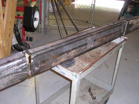1996 Ford Bronco - Custom metal bumper sections are shown on a workbench, with a spare tire in the background.