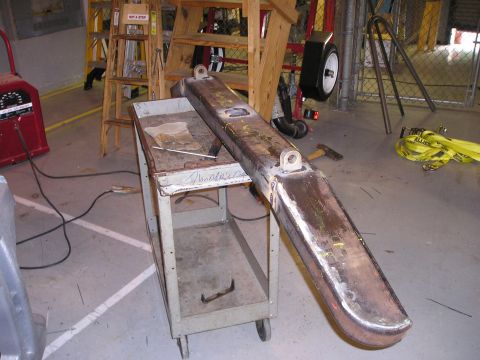 1996 Ford Bronco - A custom-fabricated steel bumper is shown on a utility cart in a workshop setting.