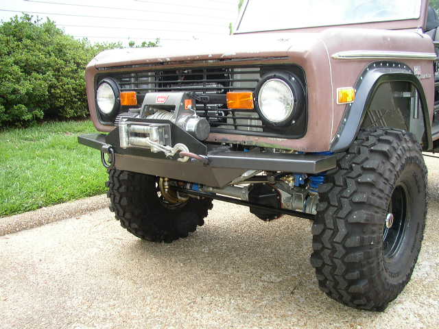 Brown 1977 Ford Bronco front view with winch and aftermarket bumper