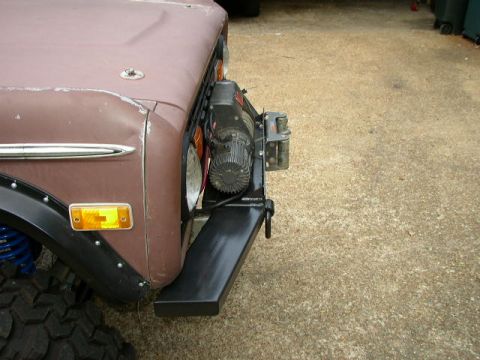 1995 Ford Bronco - The front end of a classic Ford Bronco features an aftermarket winch and bumper assembly.