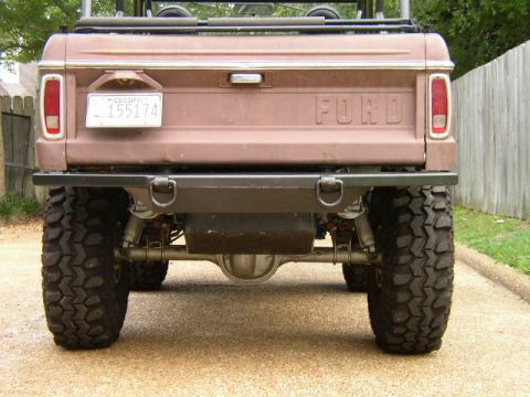 1995 Ford Bronco - This Ford Bronco features a custom rear bumper and large off-road tires, indicating off-road modifications.