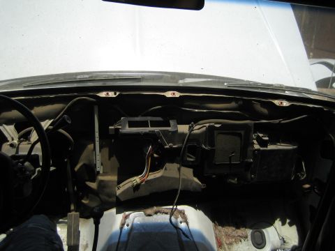 1990 Ford Bronco - dashboard has been removed exposing the bare firewall, HVAC blower box, and wiring inside a stripped vehicle interior.
