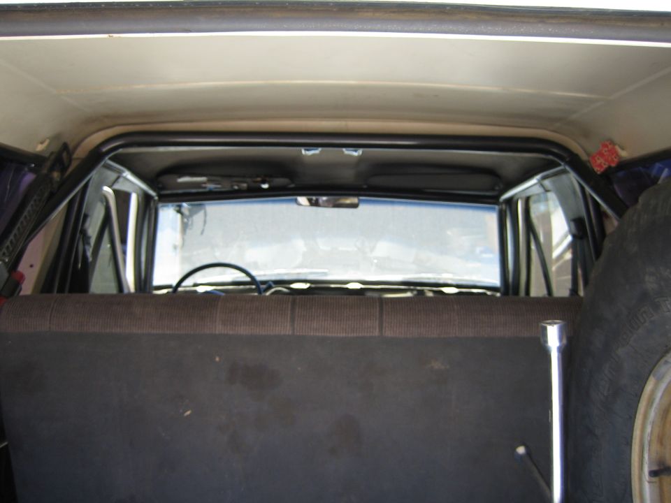 View through SUV rear cargo area toward rear window and roll bar
