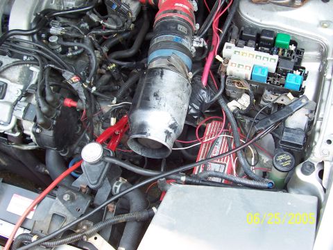 1993 Ford Probe - Close-up view of a car's engine bay, showing various components and wiring.