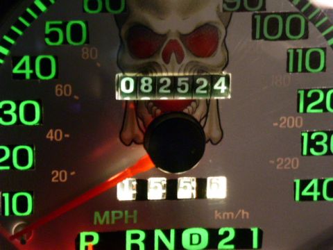 2001 Ford Crown Victoria - A car's dashboard gauge cluster displays mileage and speed, a skull graphic.