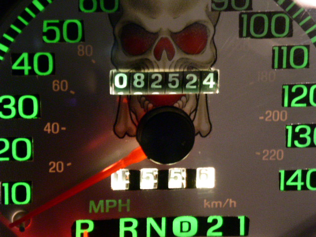 Speedometer gauge with skull graphic, showing 082524 miles and 5556 miles