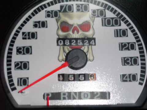 2001 Ford Crown Victoria - Custom speedometer features a skull graphic and reads 82,524 miles on the odometer.