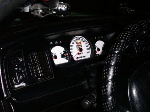 2001 Ford Crown Victoria - Custom white gauges with skull graphics in a 2001 Ford Crown Victoria interior.