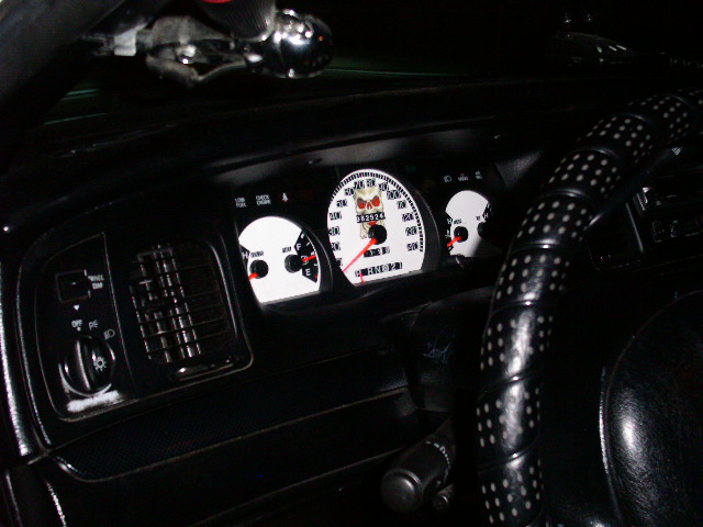 2001 Ford Crown Victoria interior showing custom white gauges with skull graphics and a black steering wheel with white dots