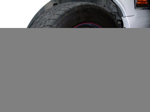 2001 Ford Crown Victoria - Close-up view of a vehicle's wheel well and tire, revealing details of the tire's condition and the wheel's rim.