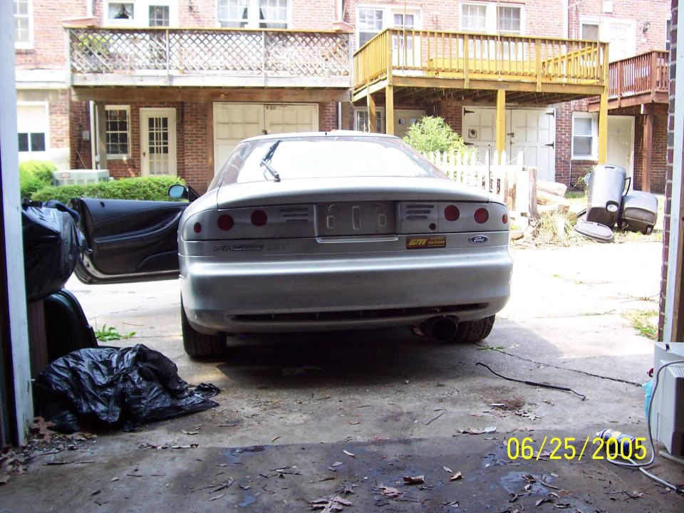 Silver 1993 Ford Probe rear view with driver door open